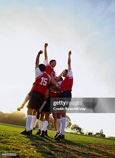 soccer team raising their arms in triumph - five a side bildbanksfoton och bilder