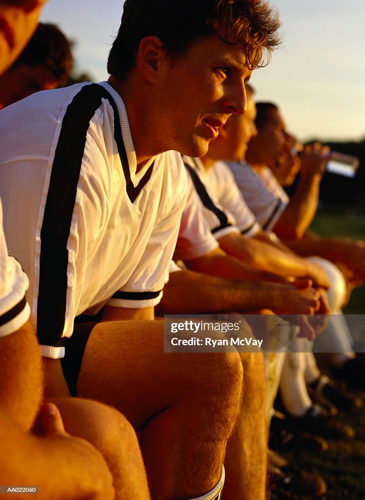 Soccer Players Sitting on a Bench