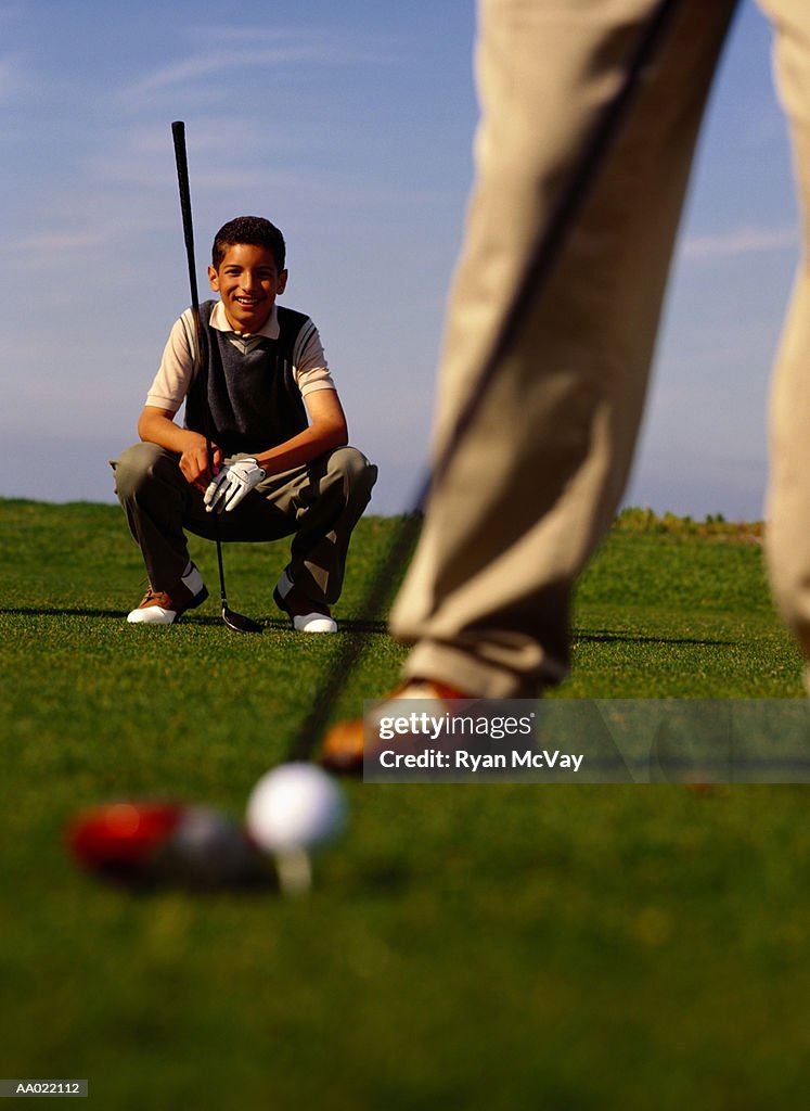 Boy Watching Father Tee Off