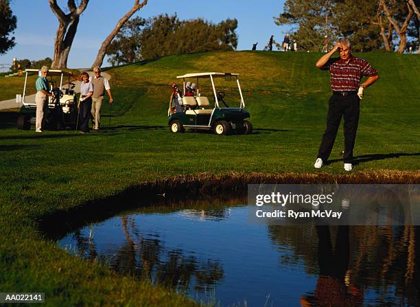 golfer looking into a waterhole - deep golf bunker stock pictures, royalty-free photos & images