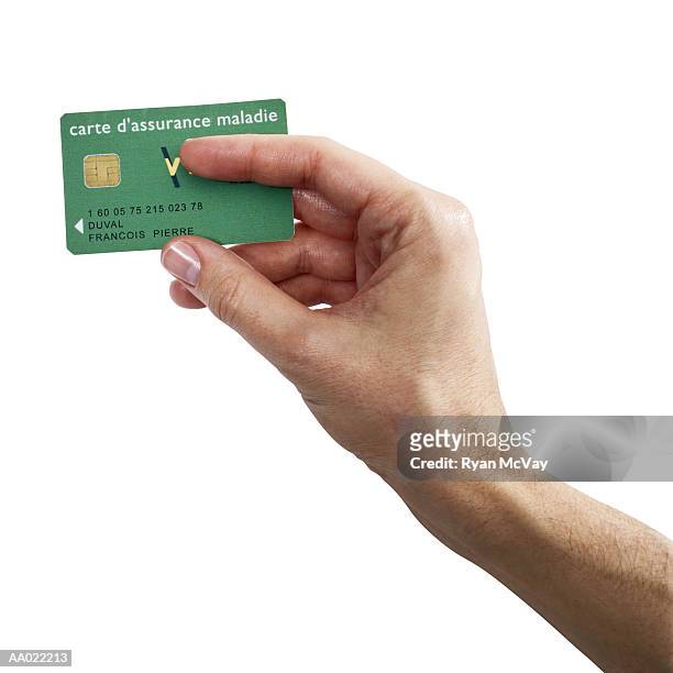 man holding french social security card - social security card foto e immagini stock