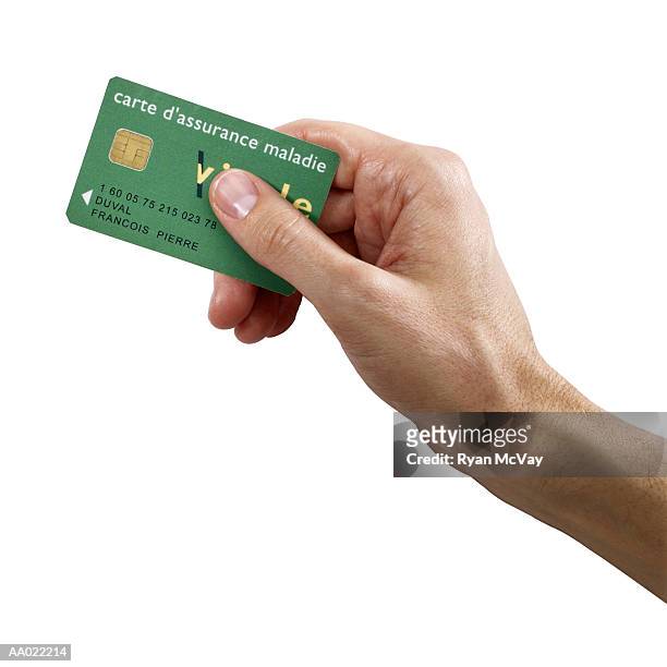 man holding french social security card - social security card foto e immagini stock