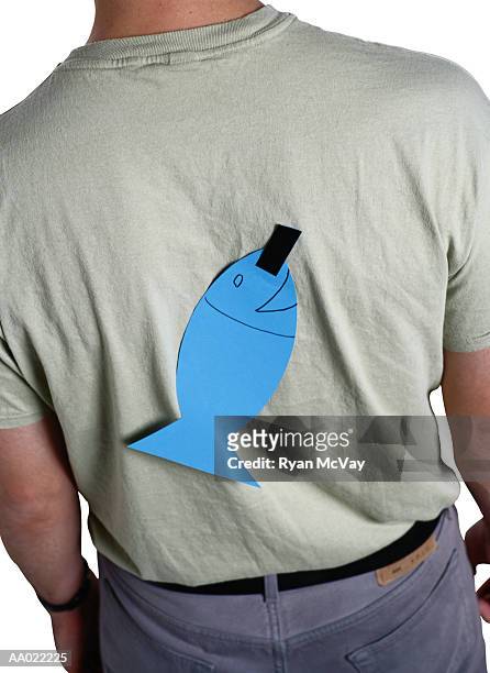 man with april fools fish stuck to his back - april fools day stock pictures, royalty-free photos & images