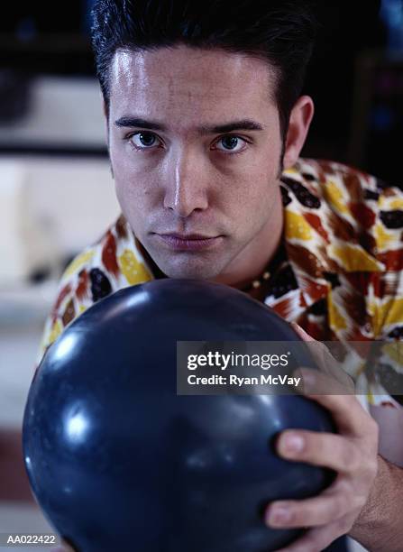 young man holding a bowling ball - man holding bowling ball stock pictures, royalty-free photos & images