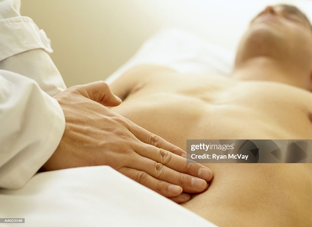 Massage Therapist Palpating the Abdomen