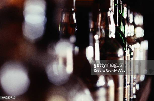 row of liquor bottles - liquor stockfoto's en -beelden
