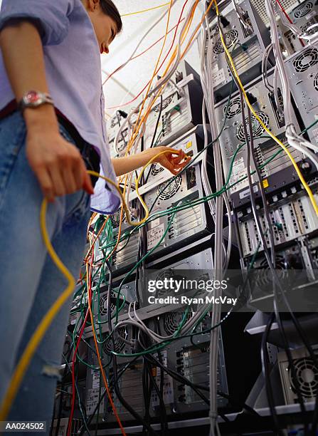 technician connecting cable to computer equipment, low angle view - porta de computador imagens e fotografias de stock