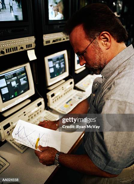 man reading by digital editing system - television studio stock pictures, royalty-free photos & images