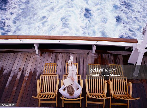 woman relaxing with book on cruise ship - cruise deck stock pictures, royalty-free photos & images