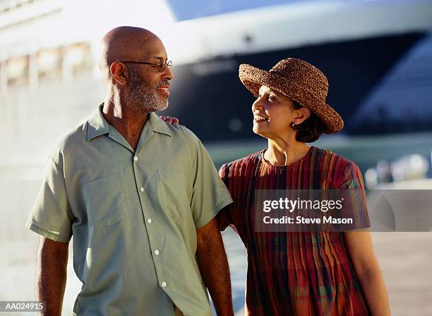 mature couple on a pier near a cruise ship - cruise ship dock stock pictures, royalty-free photos & images