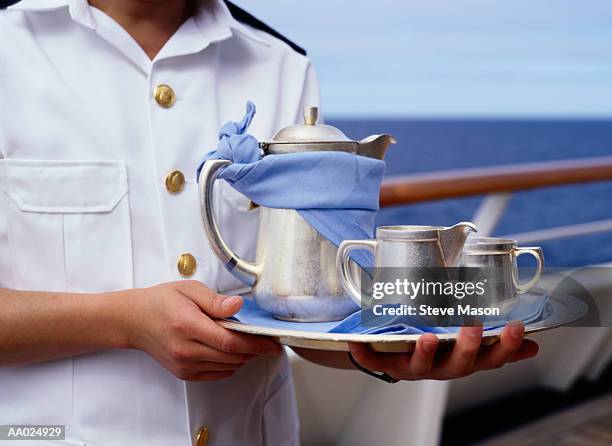 cruise ship waiter with silver service tray - metal serving tray stock pictures, royalty-free photos & images