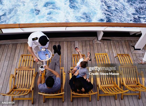 cruise ship waiter serving coffee to a passengers - cruise ship stock pictures, royalty-free photos & images