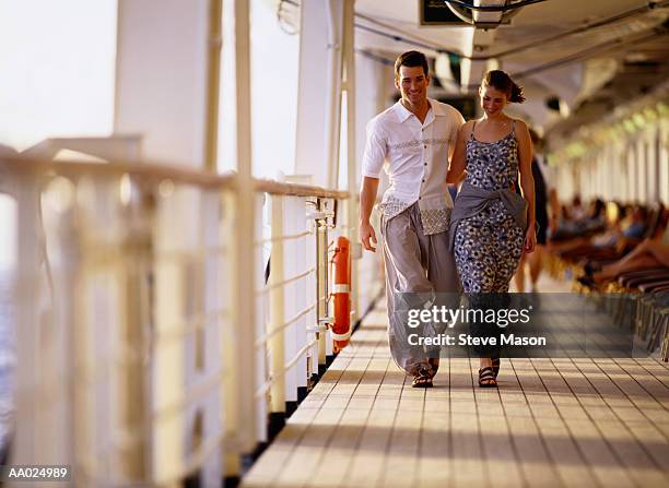 young couple arm in arm on a cruise ship - imbarcazione per passeggeri foto e immagini stock