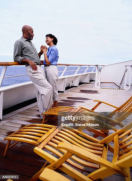 couple standing on a cruise ship deck - cruise deck stock pictures, royalty-free photos & images