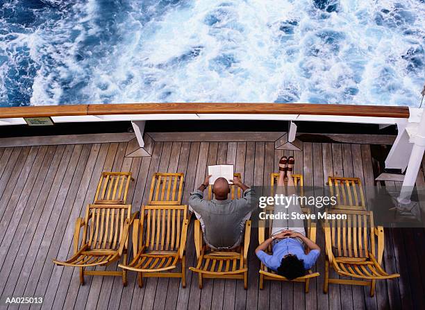 couple sitting on a cruise ship deck - schiffsdeck stock-fotos und bilder