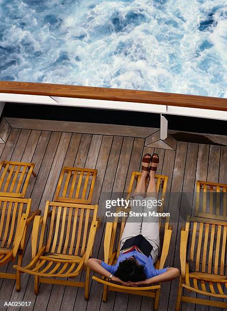 woman relaxing on a cruise ship deck - schiffsdeck stock-fotos und bilder