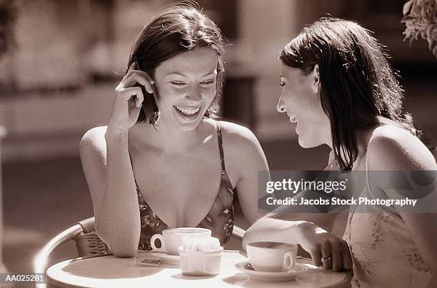 two women having coffee - two toned dress stockfoto's en -beelden