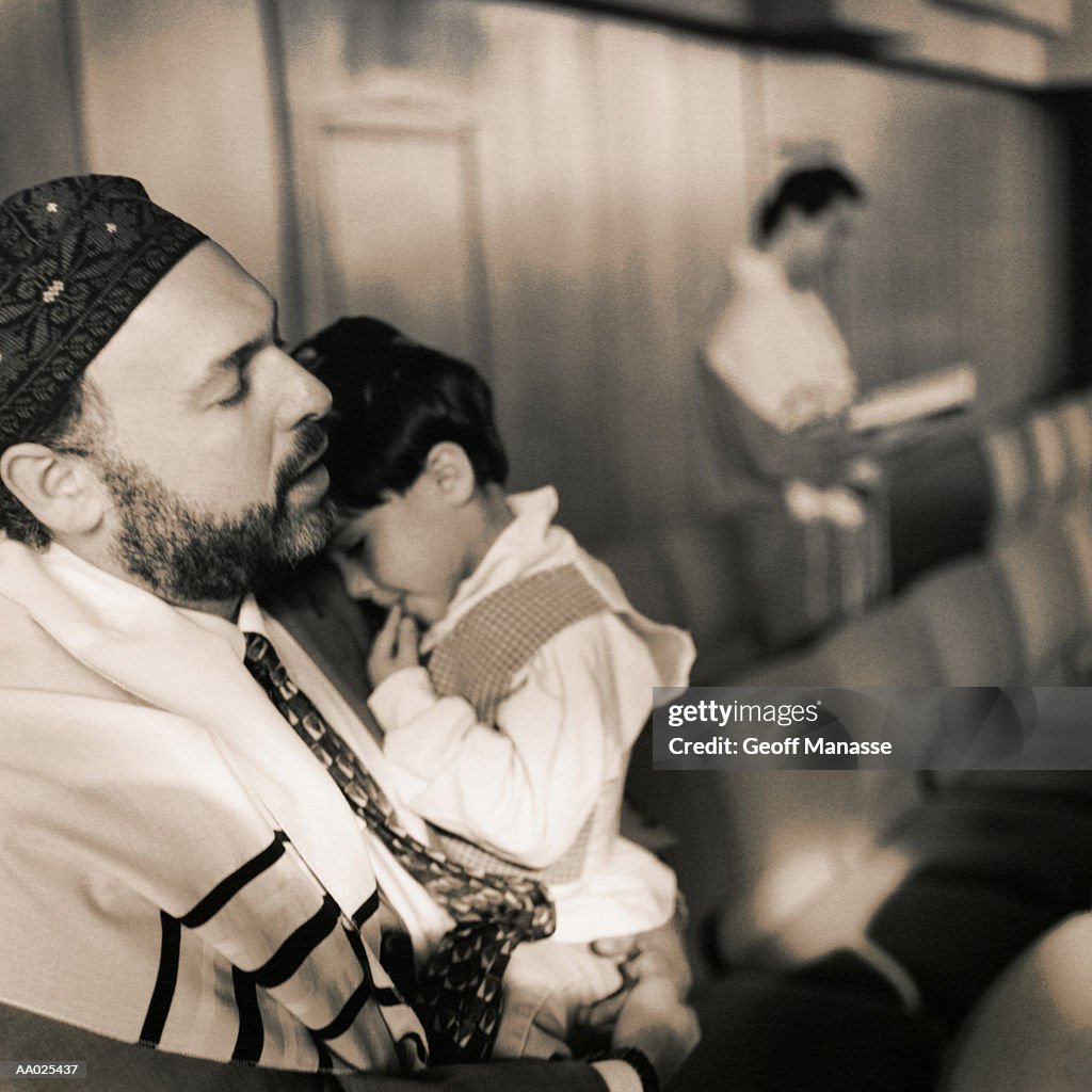 Jewish Father and Son Praying at Synagogue