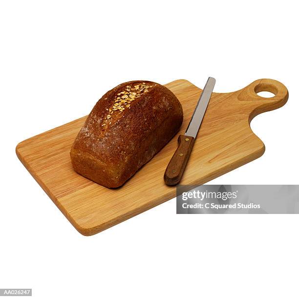 loaf of bread on wooden cutting board - loaf stock pictures, royalty-free photos & images
