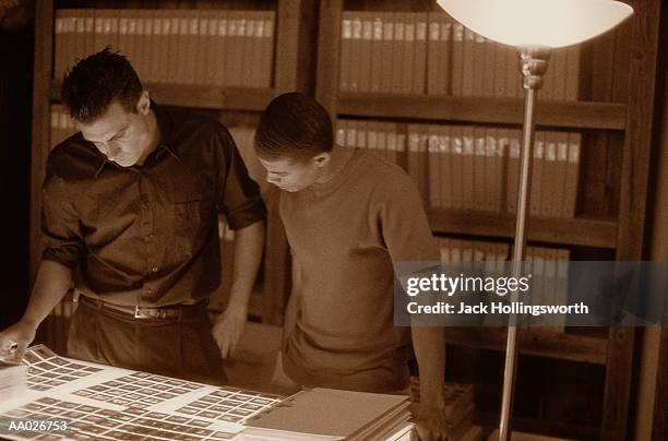 two photo editors working over a lightbox - redattore iconografico foto e immagini stock