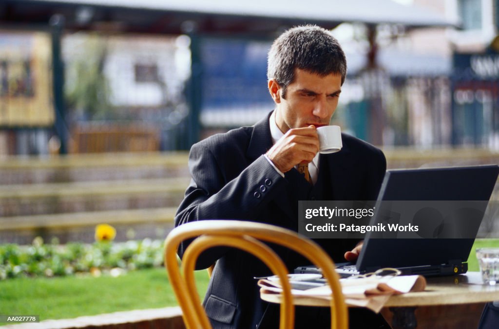 Businessman Working at a Sidewalk Cafe