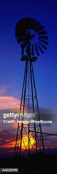 windmill at sunset - 工業用風車 ストックフォトと画像