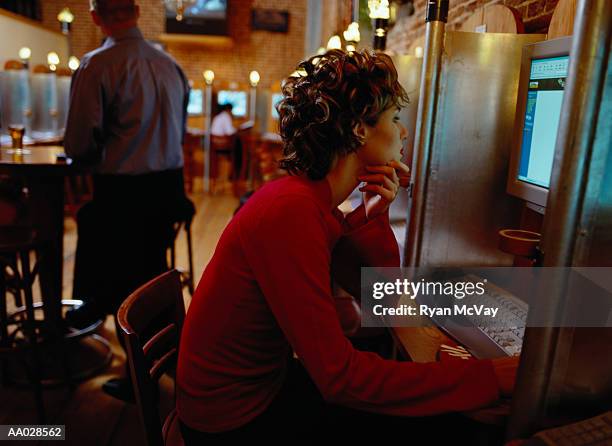 woman surfing  the web at internet cafe - internet cafe stockfoto's en -beelden