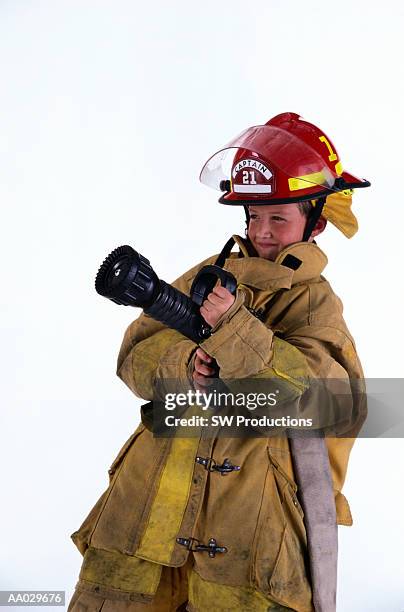 boy dressed as firefighter - boy fireman costume stock pictures, royalty-free photos & images