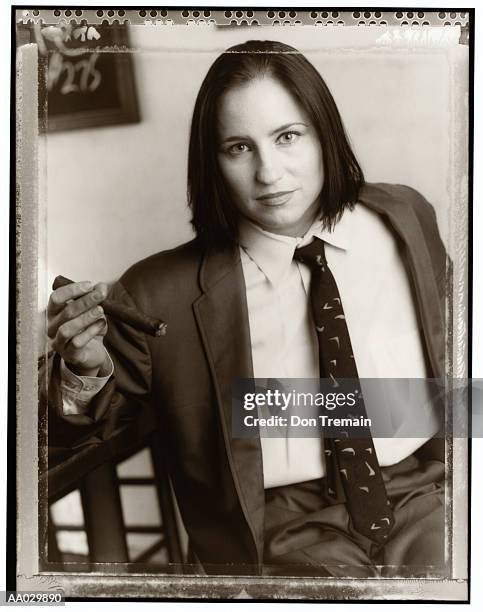 woman in man's business suit with cigar - role reversal stock pictures, royalty-free photos & images