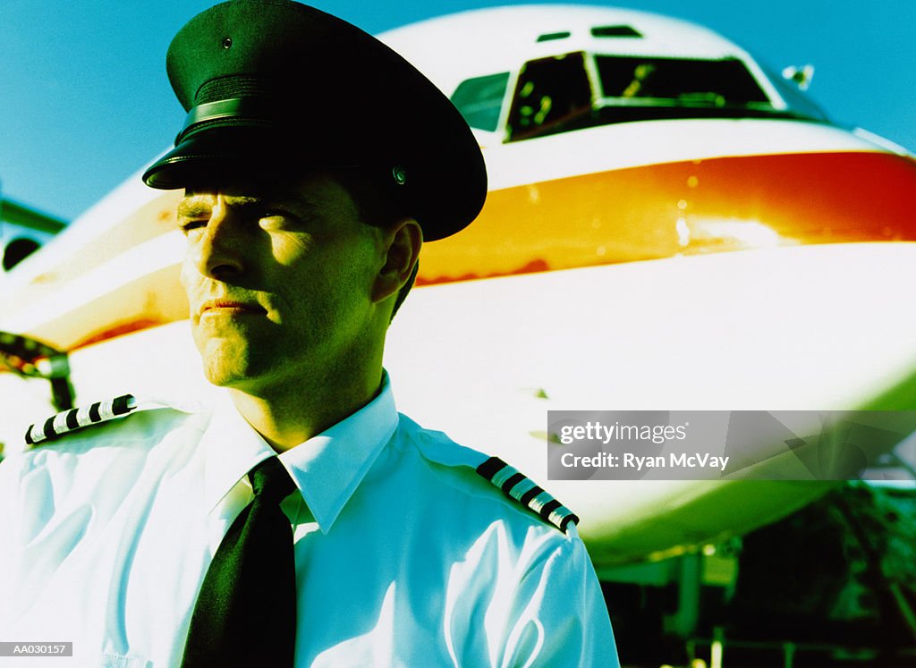 Pilot Standing in Front of Airplane