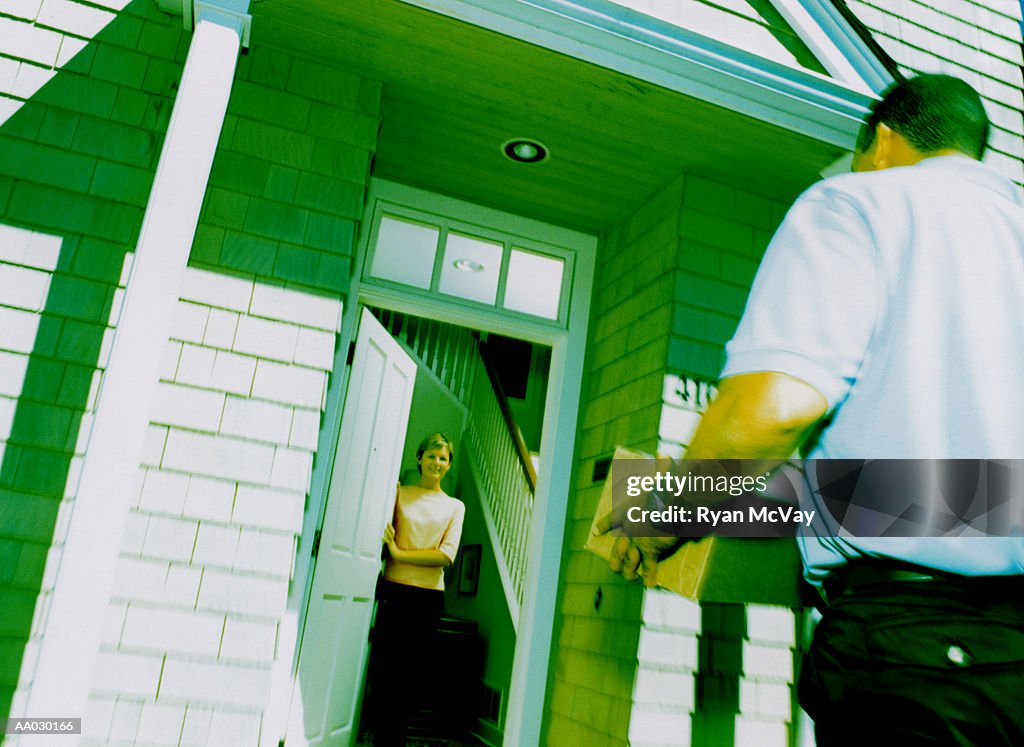 Man Delivering Package to Woman at Home