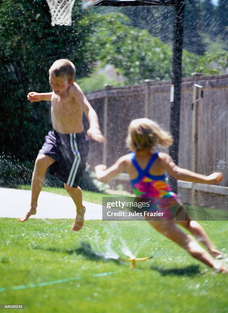Children Playing in the Sprinkler