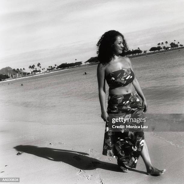 woman walking on a beach - monica askew stock pictures, royalty-free photos & images