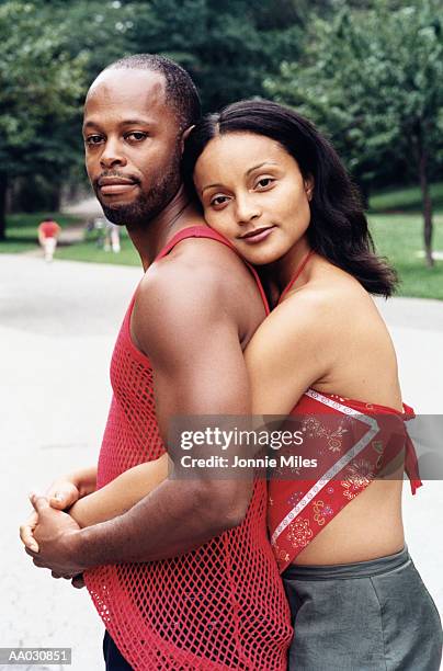 african american man and indian woman embracing - indian american woman stock pictures, royalty-free photos & images