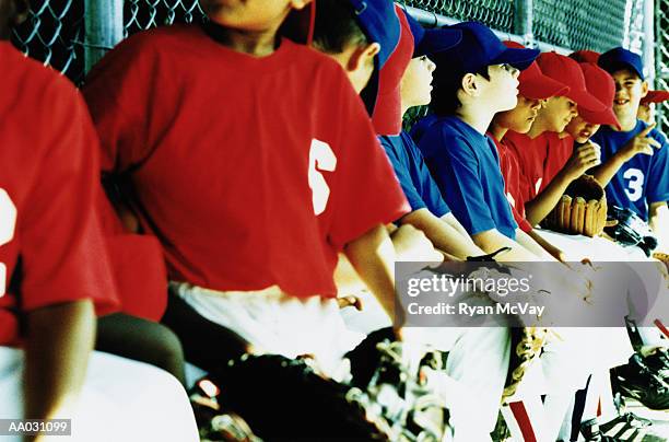 little league team in dugout - sideline baseball stock pictures, royalty-free photos & images