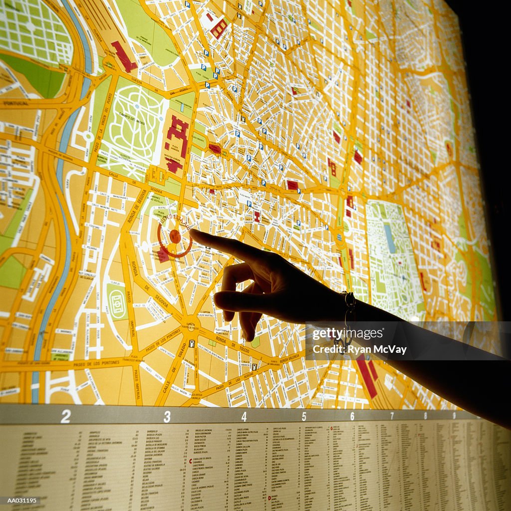 Hand Pointing at Map of Madrid