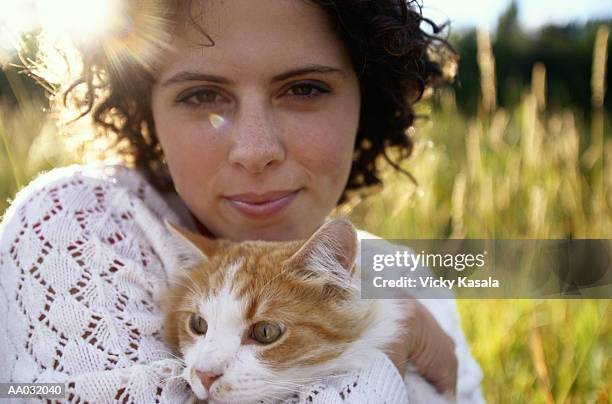 young woman holding a cat - mixed breed cat stock pictures, royalty-free photos & images