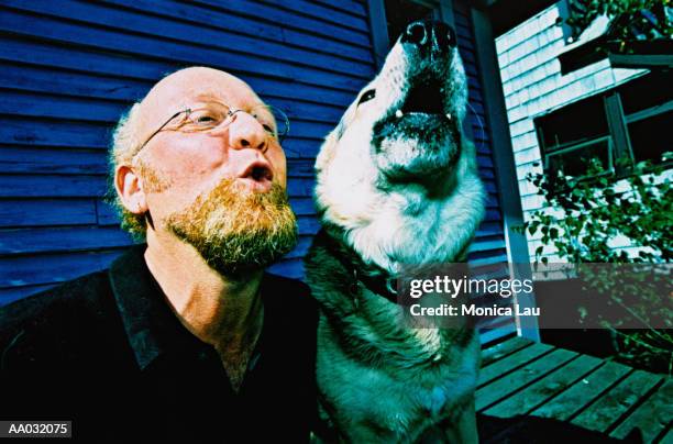 mature man and dog howling - cross processed stock pictures, royalty-free photos & images