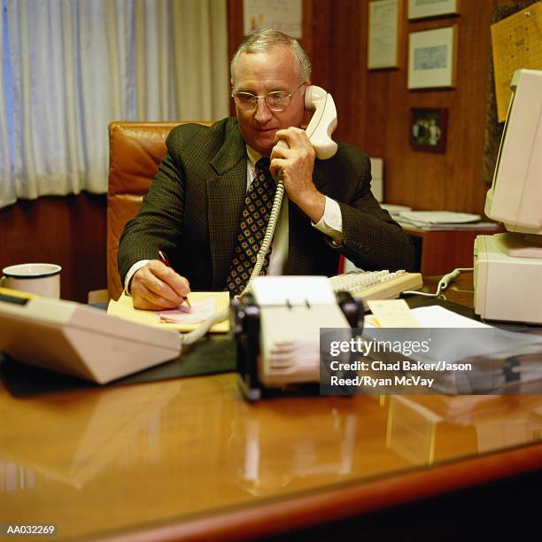 businessman in a 1970's style office - 1970 office stock pictures, royalty-free photos & images