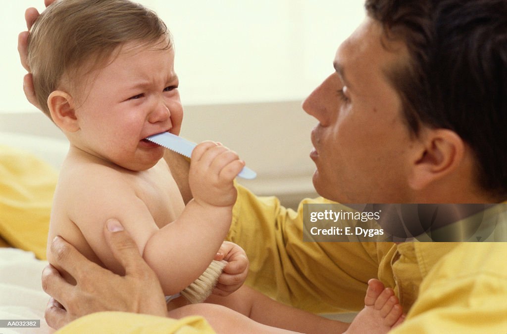 Father Comforting His Crying Infant