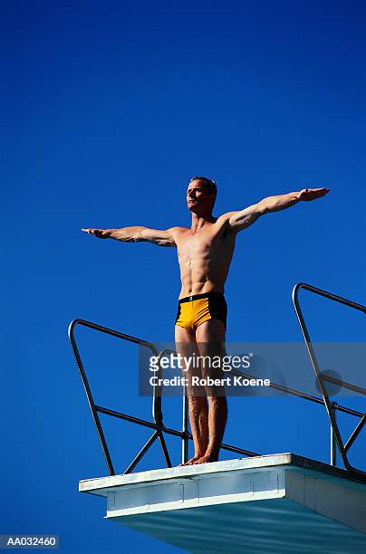 diver performing a dive - young men in speedos stock pictures, royalty-free photos & images