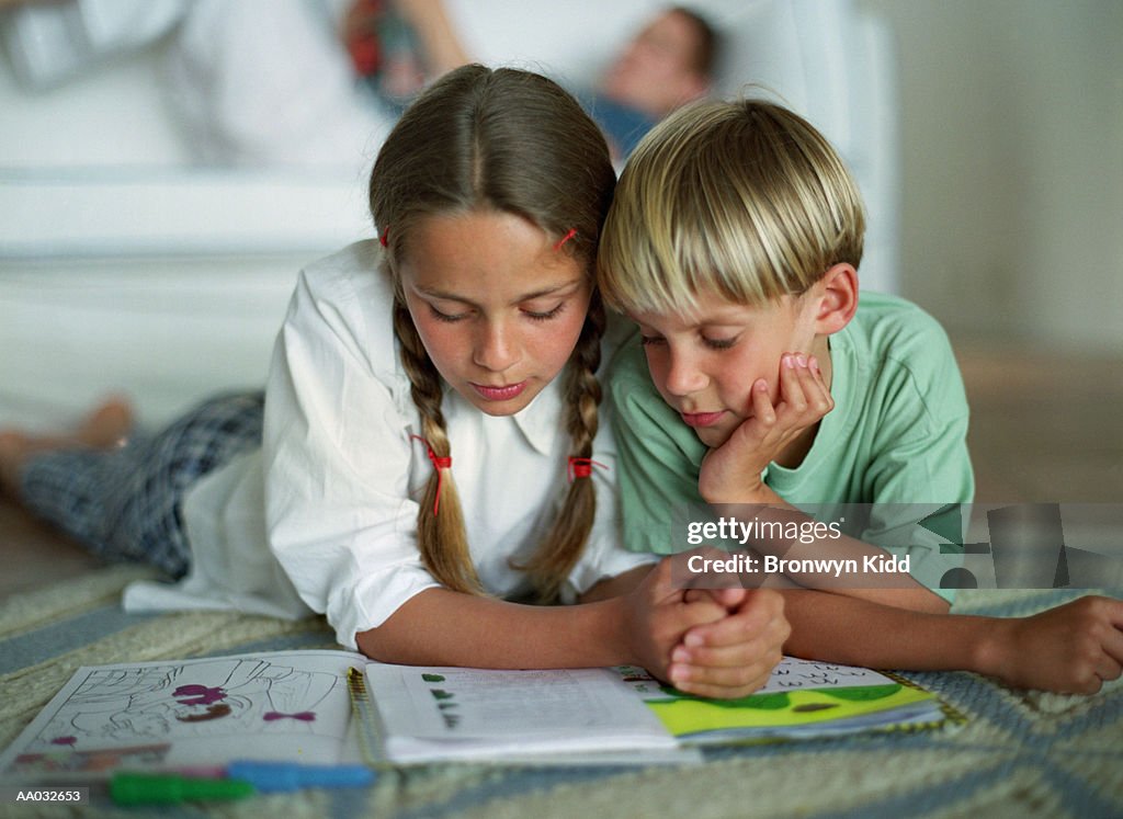 Brother & Sister Reading a Book Together