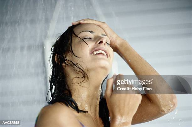 woman taking a shower - women taking showers stock pictures, royalty-free photos & images