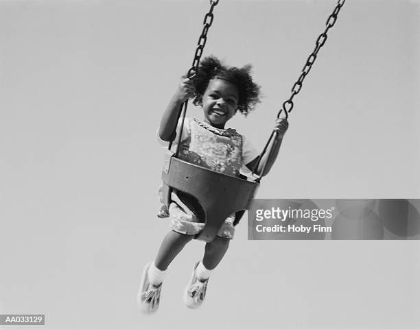 young girl on a swing - children swinging stock pictures, royalty-free photos & images