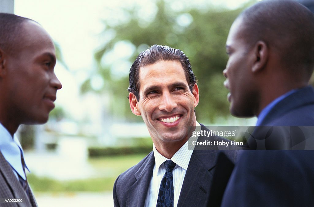 Three Businessmen Having a Conversation