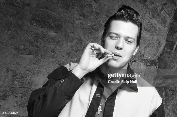 young man smoking - 50s rockabilly men stock pictures, royalty-free photos & images
