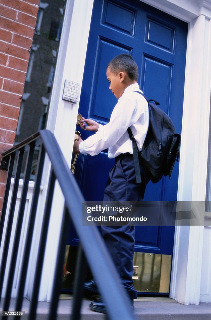 Boy Unlocking His Front Door