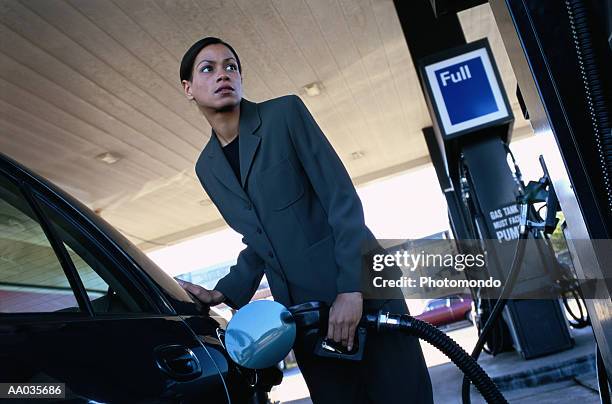 woman at a gas station - supreme fiction stock pictures, royalty-free photos & images