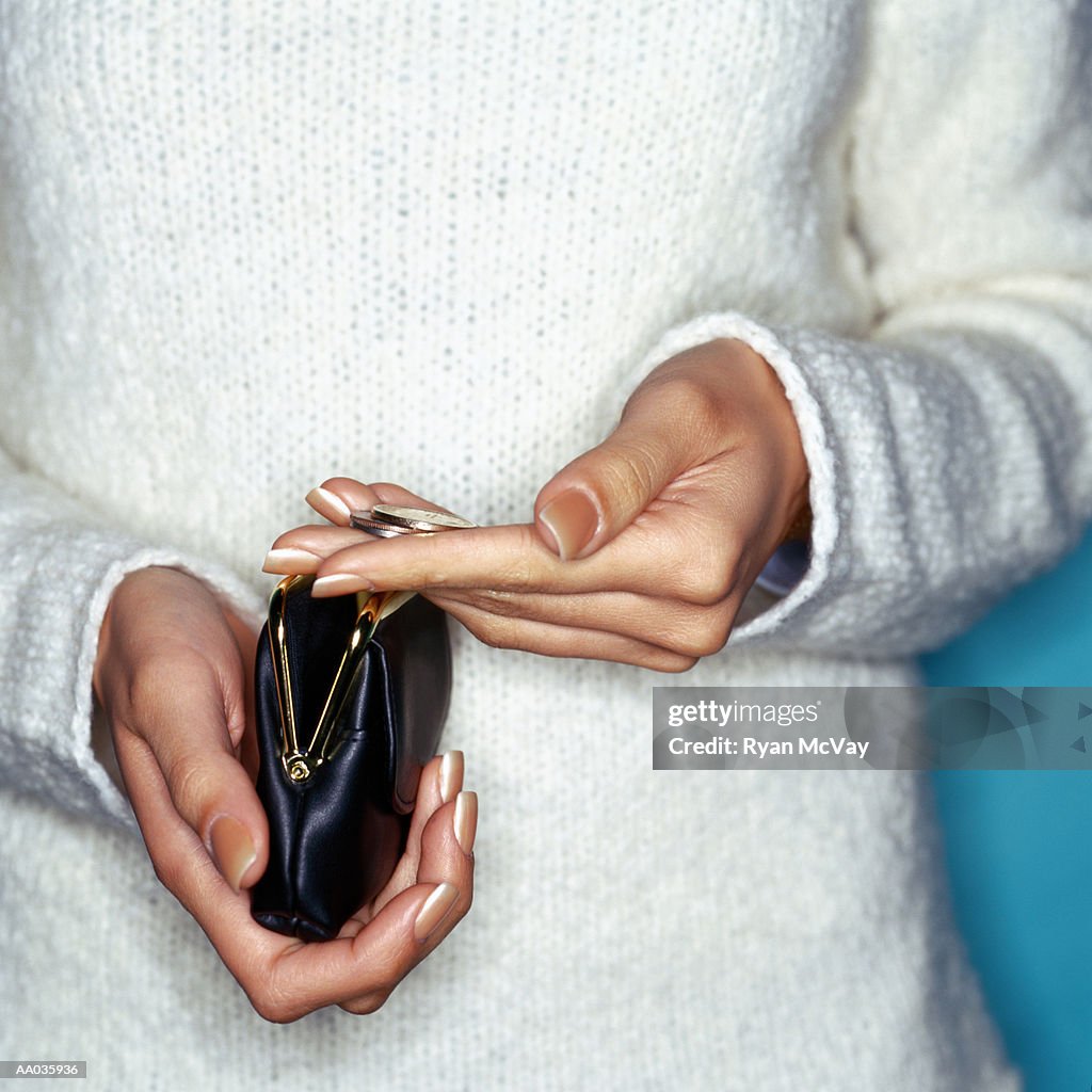 Woman Searching For Coins in Change Purse