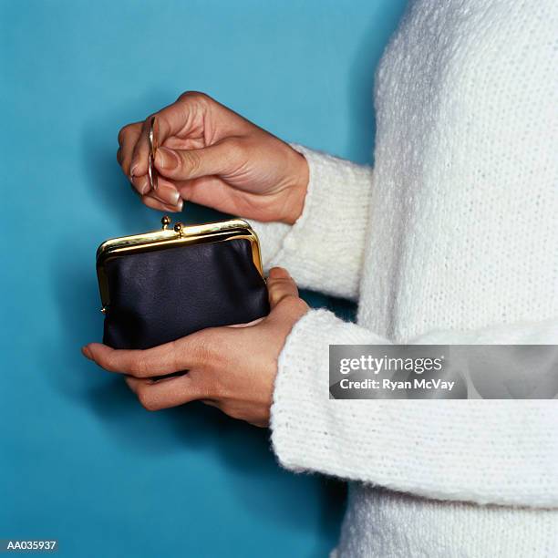 woman searching for coins in change purse - searching for something ストックフォトと画像